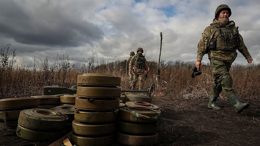 <div class="paragraphs"><p>Members of the National Police special demining unit walk past deactivated mines during a demining operation near Izum town, amid Russia's attack on Ukraine, in Kharkiv region, Ukraine, October 24, 2023. </p></div>