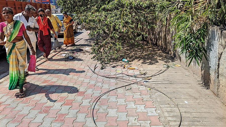 <div class="paragraphs"><p>Pedestrians walk past the spot of the accident, where a woman and her nine-month-old baby were electrocuted.&nbsp;</p></div>