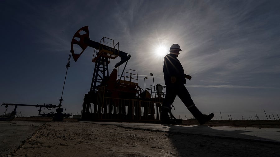 <div class="paragraphs"><p>An oil and gas industry worker walks during operations of a drilling rig.&nbsp;</p></div>