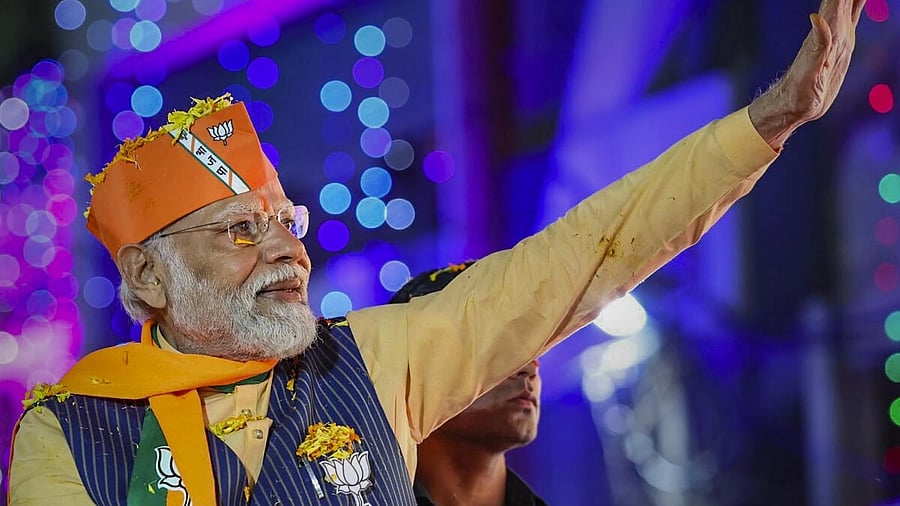 <div class="paragraphs"><p>Prime Minister Narendra Modi waves at supporters during a roadshow ahead of the Madhya Pradesh Assembly elections, in Indore, Tuesday, Nov. 14, 2023.</p></div>