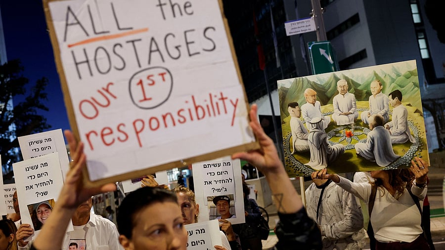 <div class="paragraphs"><p>Protesters hold signs demanding the liberation of hostages who are being held in the Gaza Strip after they were seized by Hamas gunmen on October 7, in Tel Aviv, Israel November 21, 2023. </p></div>