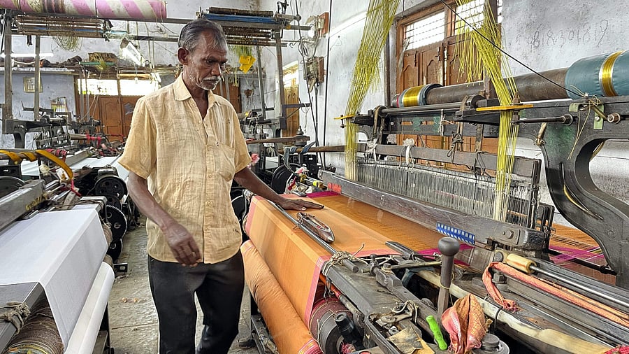 <div class="paragraphs"><p>A textile worker weaves a ''Bathukamma' saree on a power loom, at Telangana's Sircilla Assembly constituency.&nbsp;</p></div>