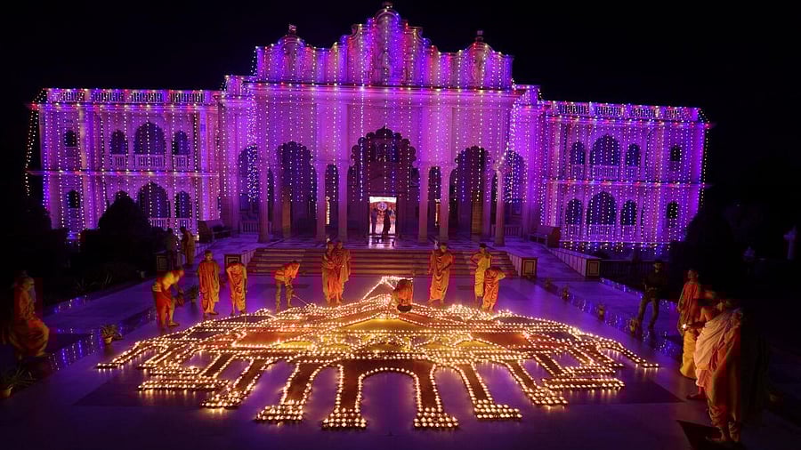 <div class="paragraphs"><p>Hindu saints and devotees light oil lamps in a formation of the Ayodhya Ram temple inside a temple to celebrate Diwali, the Hindu festival of lights, in Ahmedabad, India, November 12, 2023.</p></div>