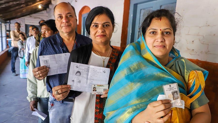<div class="paragraphs"><p>People wait with their identity cards to cast their votes for the Assembly elections, in Jabalpur, Madhya Pradesh. </p></div>