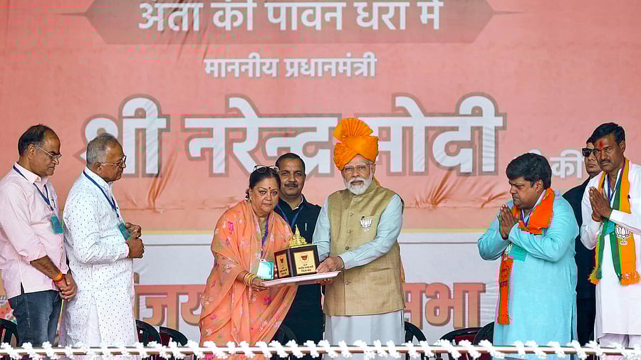 <div class="paragraphs"><p>Prime Minister Narendra Modi with former Rajasthan chief minister Vasundhara Raje during a public meeting ahead of Rajasthan Assembly elections, at Anta in Baran district, Tuesday, </p></div>