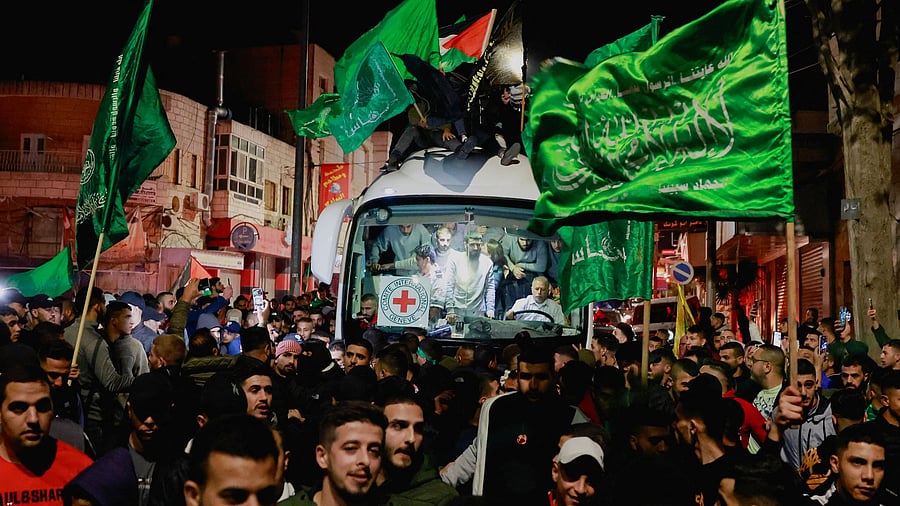 <div class="paragraphs"><p>Released Palestinian prisoners react from inside a vehicle after leaving the Israeli military prison, Ofer, amid a hostages-prisoners swap deal between Hamas and Israel, near Ramallah in the Israeli-occupied West Bank November 26, 2023. </p></div>