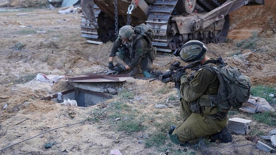 <div class="paragraphs"><p>Israeli soldiers inspect the entrance to what they say is a tunnel used by militants of the Palestinian Islamist group Hamas, during a ground operation in a location given as Gaza, in this handout image released November 9, 2023.</p></div>