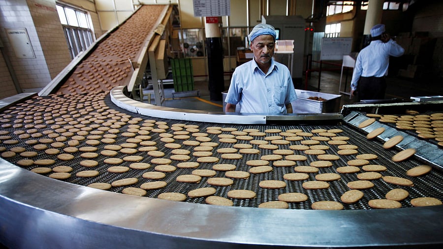 <div class="paragraphs"><p>A worker stands next to a production line at the Britannia biscuit factory in New Delhi. </p></div>