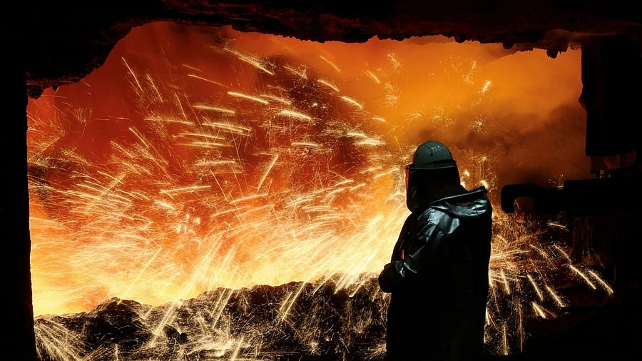 <div class="paragraphs"><p>A steel worker in heat protection gear is silhouetted against the sparkling fire of Europe's largest furnace with a daily raw iron production of 12,000 tons, at the steel plant of ThyssenKrupp in Duisburg, Germany, November 16, 2023.  </p></div>