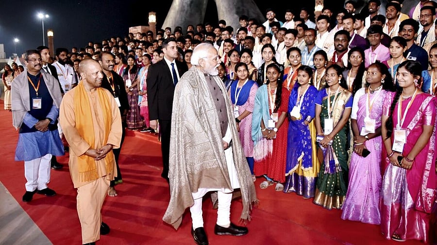 <div class="paragraphs"><p>Prime Minister Narendra Modi with Union Minister Dharmendra Pradhan and Uttar Pradesh Chief Minister Yogi Adityanath during the inauguration of the Kashi Tamil Sangamam 2.0, at Namo Ghat in Varanasi, Sunday, Dec. 17, 2023.</p></div>