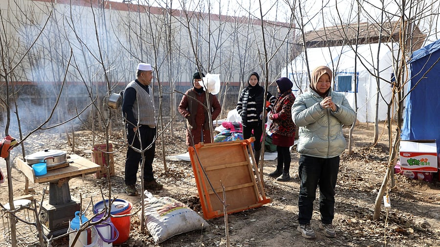 <div class="paragraphs"><p>A woman weeps next to emergency tents set up for quake-affected victims at Sibuzi village following the earthquake in Jishishan county, Gansu province, China December 21, 2023. </p></div>