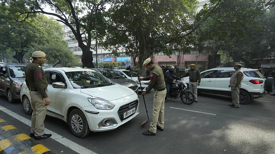 <div class="paragraphs"><p>Security personnel check a vehicle near the Parliament House after a security breach.</p></div>