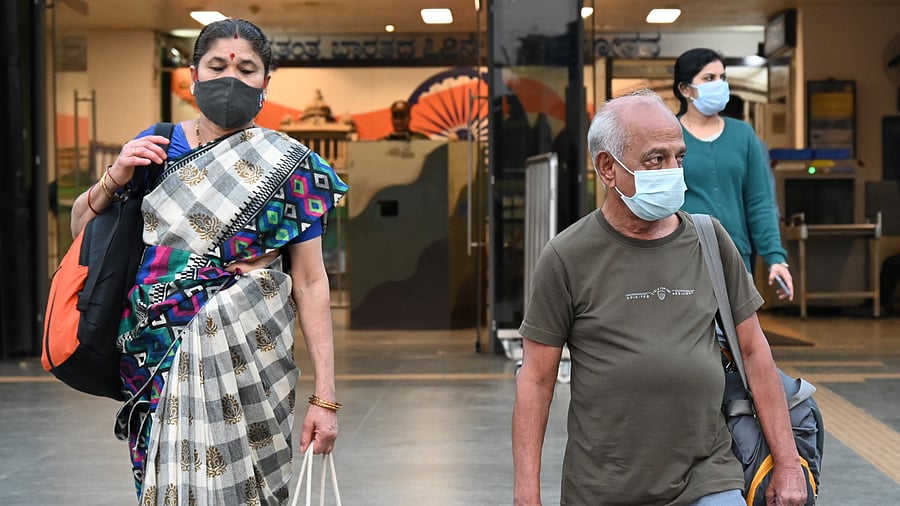 <div class="paragraphs"><p>Commuters, wearing masks, come out of the Kempegowda Metro Station in Bengaluru on Wednesday. The government has told senior citizens to wear masks in public places in the wake of the Covid scare. </p></div>