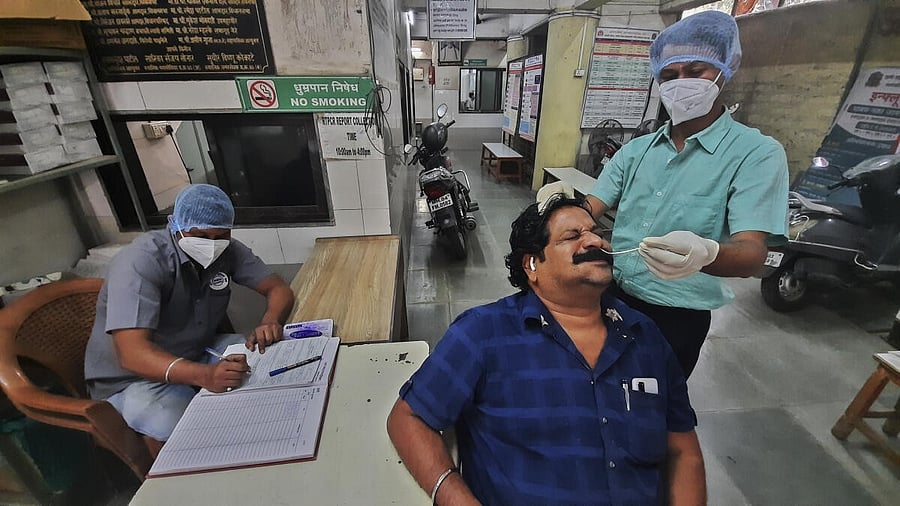 <div class="paragraphs"><p>Health officials perform Covid-19 test on a man.</p></div>