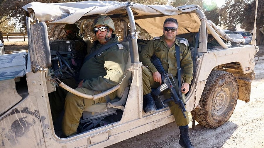 <div class="paragraphs"><p>Israeli members of the military sit in a vehicle near the Gaza Strip border.</p></div>