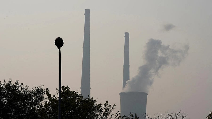 <div class="paragraphs"><p>A cooling tower and chimneys are seen at a thermal power plant on a polluted day in Beijing</p></div>