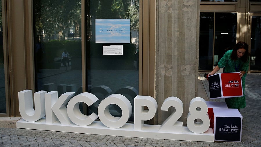 <div class="paragraphs"><p>A delegate arranges a display outside the United Kingdom pavilion at the Dubai's Expo City, during the United Nations Climate Change Conference  in Dubai, United Arab Emirates, December 4, 2023. </p></div>