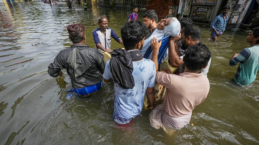 <div class="paragraphs"><p>People help an elderly woman shift to a safer place from a flooded area after heavy rainfall owing to Cyclone Michaung, in Chennai.</p></div>