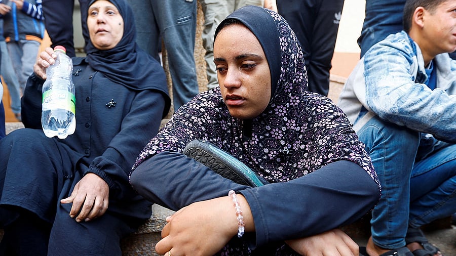 <div class="paragraphs"><p>Razan Ashram holds her husband's shoes, who was killed in an Israeli raid, amid the ongoing conflict between Israel and the Palestinian Islamist group Hamas, during his funeral at Nasser hospital in Khan Younis, in the southern Gaza Strip.</p></div>