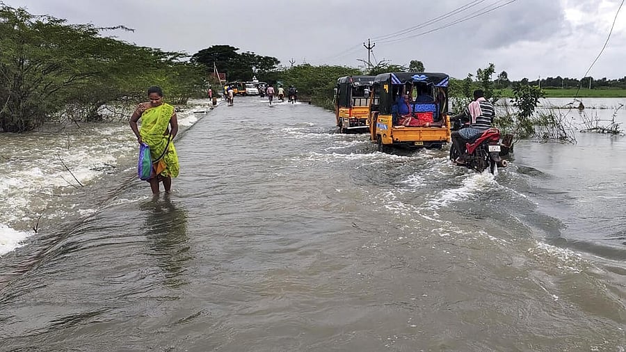<div class="paragraphs"><p>A local wades through a waterlogged road after heavy rain owing to Cyclone Michaung, in Tirupati, Andhra Pradesh, Monday, Dec 4, 2023.</p></div>