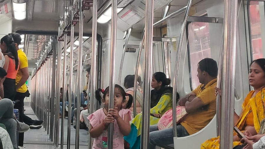 <div class="paragraphs"><p>Passengers in a Delhi metro train.</p></div>