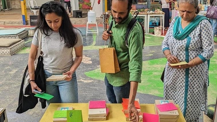 <div class="paragraphs"><p>People sift through 'mystery books' at a stall by Whispering Pages in Bengaluru.</p></div>