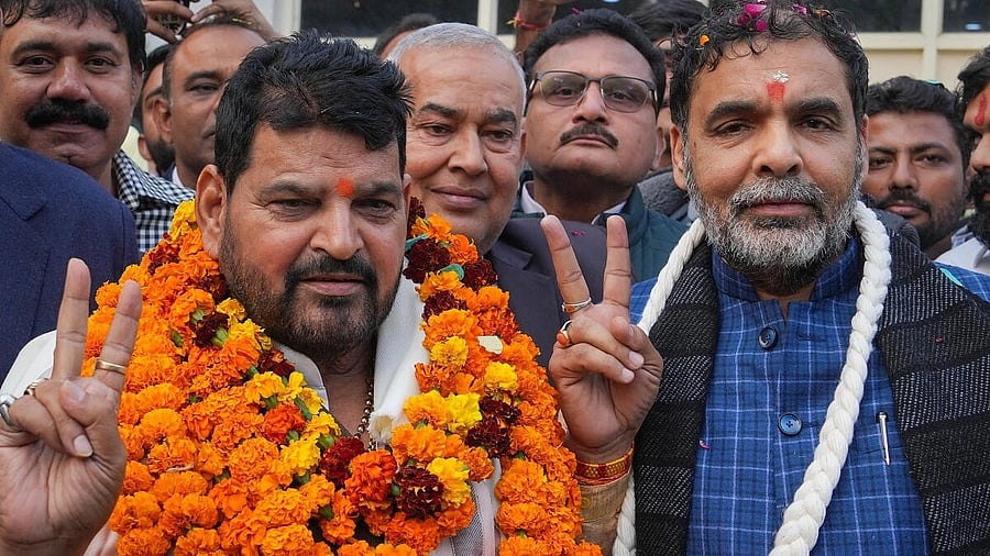 <div class="paragraphs"><p>Sanjay Singh (right) with BJP MP Brij Bhushan Sharan Singh.</p></div>