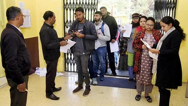 <div class="paragraphs"><p>Candidates getting their documents checked as they arrive to appear for the Madhya Pradesh Public Service Commission (MPPSC) exam, at an examination centre in Jabalpur, Sunday, Dec 17, 2023.</p></div>