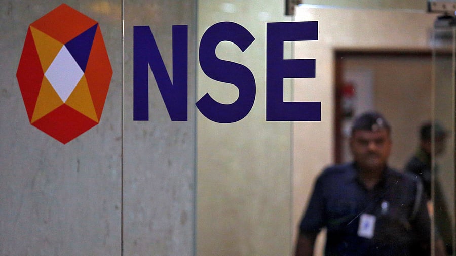 <div class="paragraphs"><p>A security guard walks past the logo of the National Stock Exchange (NSE) inside its building in Mumbai. </p></div>