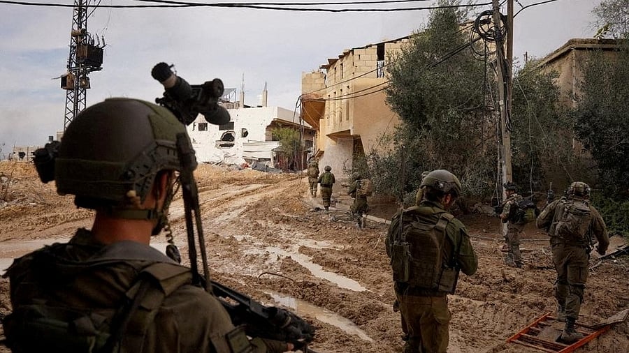 <div class="paragraphs"><p>Israeli soldiers walk during their ground operation against Palestinian Islamist group Hamas at a location given as Khan Younis, Gaza Strip in this handout image released December 24, 2023. </p></div>