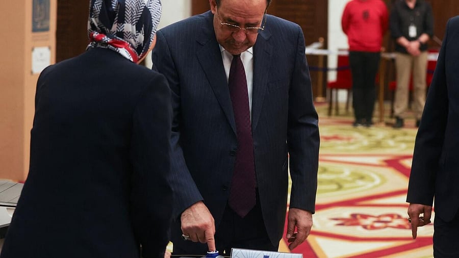 <div class="paragraphs"><p>Former Iraqi Prime Minister Nouri al-Maliki dips his finger in the ink at a polling station, as he votes in Iraq's provincial council elections, in Baghdad, Iraq.</p></div>