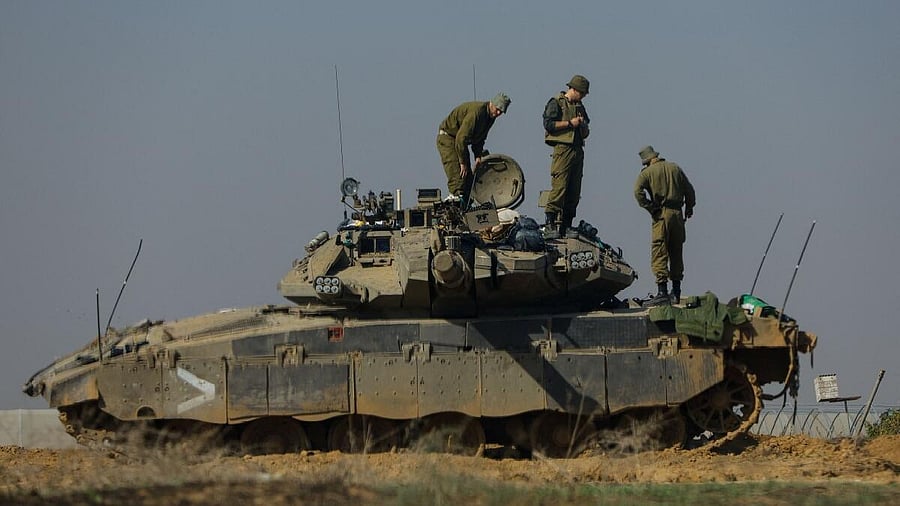 <div class="paragraphs"><p>Israeli soldiers work on a&nbsp;tank&nbsp;near the border with Gaza, amid the ongoing conflict between Israel and the Palestinian Islamist group Hamas, as seen from southern Israel.</p></div>