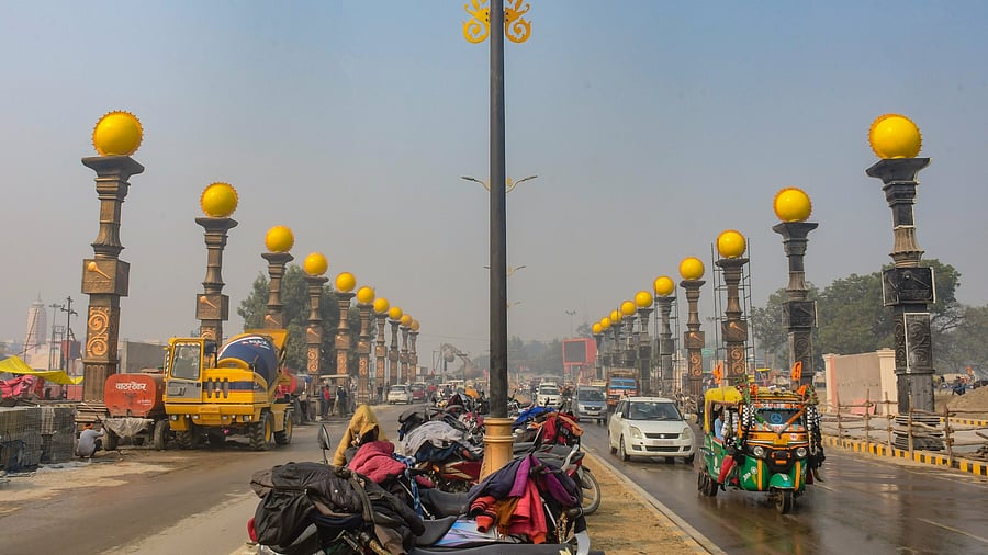 <div class="paragraphs"><p>Vehicles move on a road adorned with 'Surya Stambhs' ahead of the consecration ceremony of the Lord Ram temple, in Ayodhya, Wednesday, December 27, 2023.</p></div>
