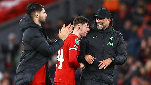 <div class="paragraphs"><p>Liverpool's Conor Bradley celebrates with manager Juergen Klopp after Liverpool v West Ham United quarter final at Anfield, Liverpool, Britain, on December 20, 2023</p></div>