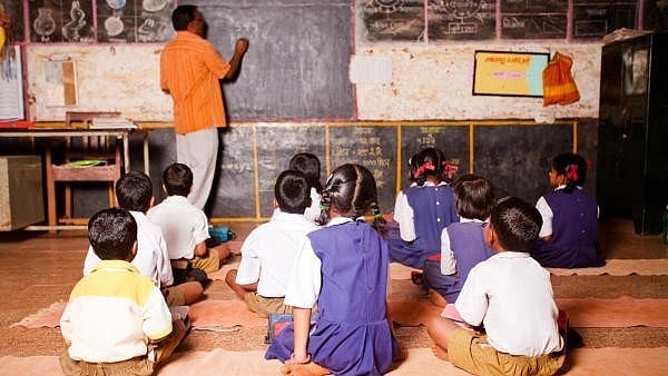 <div class="paragraphs"><p>Image of a male teacher teaching in a rural school of India.</p></div>