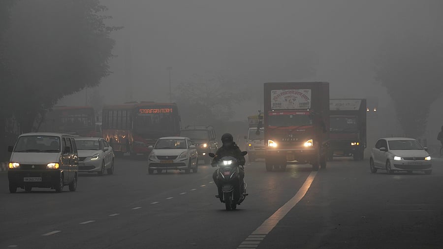 <div class="paragraphs"><p>Vehicles ply on road amid low visibility during fog on a cold winter morning, in New Delhi, Sunday, Jan. 14, 2024. </p></div>