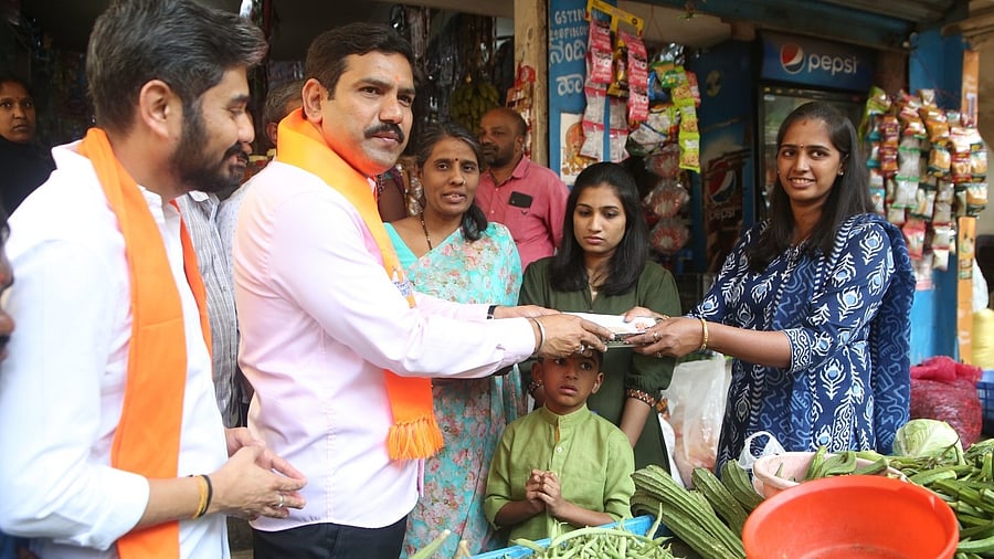 <div class="paragraphs"><p>BJP state President and MLA B Y Vijayendra take part in the Door-to-door 'Mantrakshate' campaign, at Sheshadripura area in Bengaluru on Sunday. </p></div>