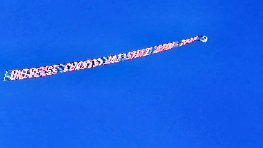 <div class="paragraphs"><p>An aerial banner reads: Universe Chants Jai Shree Ram crosses Houston skies.</p></div>