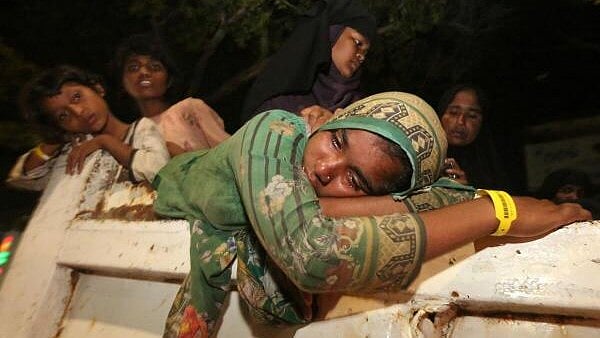 <div class="paragraphs"><p>A Rohingya Muslim woman reacts while on a truck in Indonesia.</p></div>