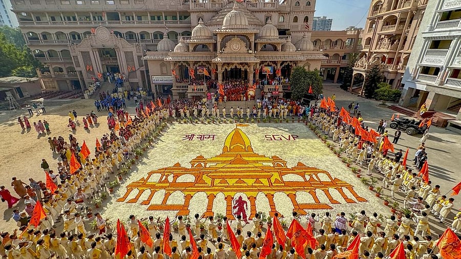 <div class="paragraphs"><p>Devotees pray next to a 'Rangoli' of Ram Mandir to mark its consecration ceremony, inside the Swaminarayan temple in Ahmedabad.</p></div>