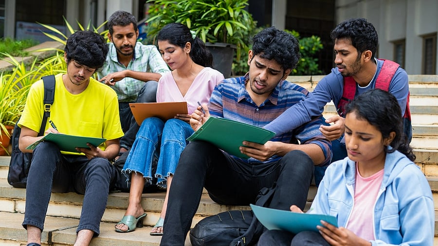 <div class="paragraphs"><p>Group of students filling admission application form or preparing for exams on college campus by discussing eachother - concept of graduation, skill development and examination Group of students filling admission application form or preparing for exams on college campus by discussing with each other - concept of graduation, skill development and examination</p></div>