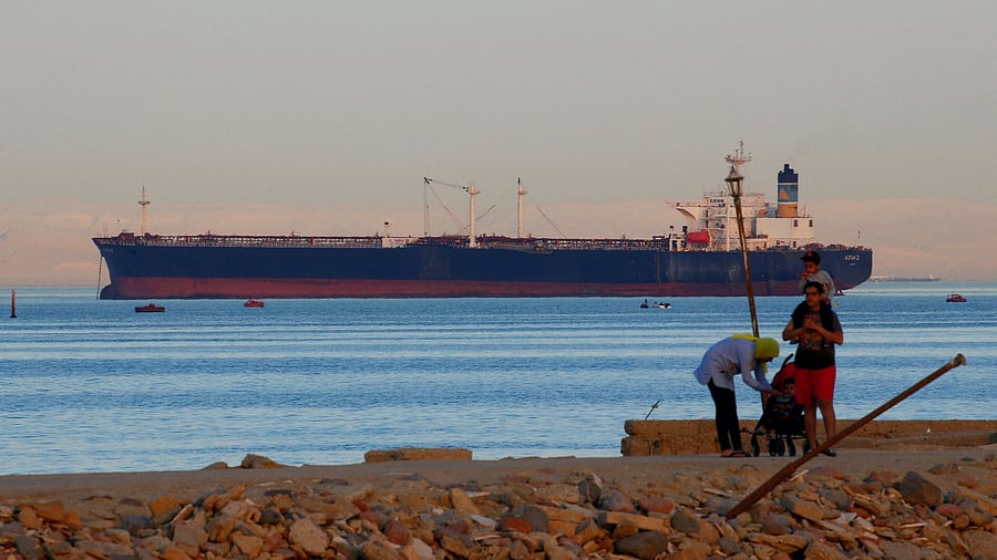 <div class="paragraphs"><p> People walk on the beach as a container ship crosses the Gulf of Suez towards the Red Sea before entering the Suez Canal, in El Ain El Sokhna in Suez, east of Cairo, Egypt April 24, 2017.</p></div>