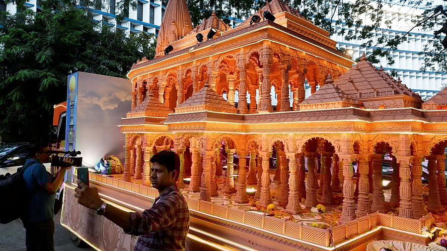 <div class="paragraphs"><p>A man takes a selfie with a replica of the Ram Mandir outside the BJP headquarters in Mumbai.</p></div>