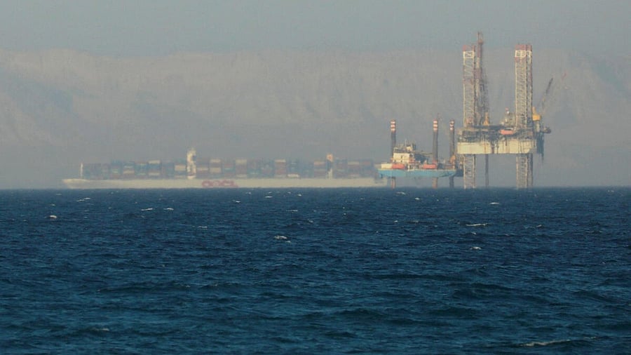 <div class="paragraphs"><p>A container ship crosses an oil platform at the Gulf of Suez towards the Red Sea before entering the Suez Canal, outside of Cairo, Egypt.</p></div>