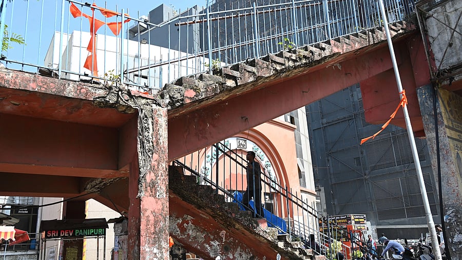 Cracked bricks and structural damage are evident in the skywalk on KG Road in Bengaluru on Saturday.