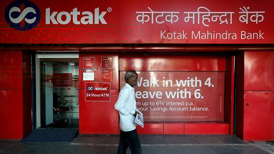 <div class="paragraphs"><p>A man walks past the Kotak Mahindra Bank branch in New Delhi, India,.</p></div>