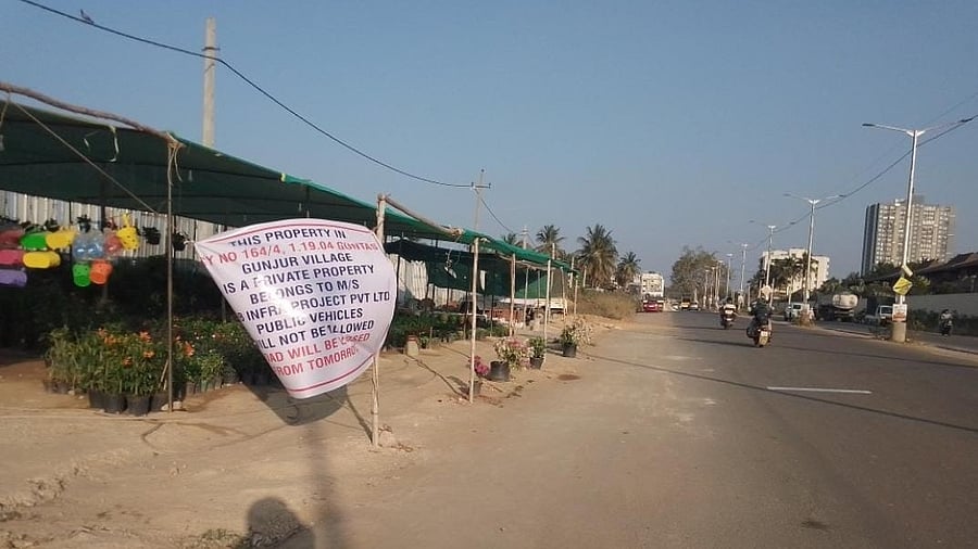 <div class="paragraphs"><p>Several posters have been put up on the 2-km Varthur-Gunjur road that the BBMP has built by acquiring private properties. </p></div>