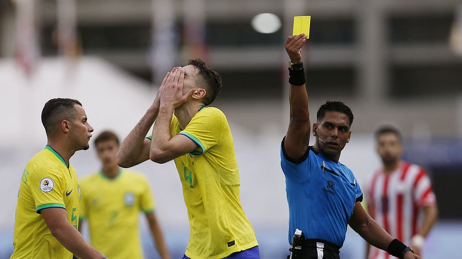 <div class="paragraphs"><p>A representative image showing  referee Roberto Perez cautioning  Brazil's Arthur Chaves as he raises a yellow card during a game.</p></div>