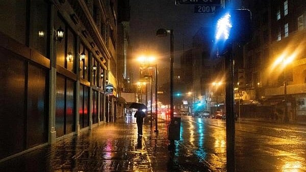 <div class="paragraphs"><p>A person walks downtown during heavy rains in Los Angeles, California, US.</p></div>