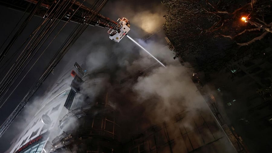 <div class="paragraphs"><p>Firefighters spray water to douse a fire that broke out in a multi-storey building in Dhaka.</p></div>